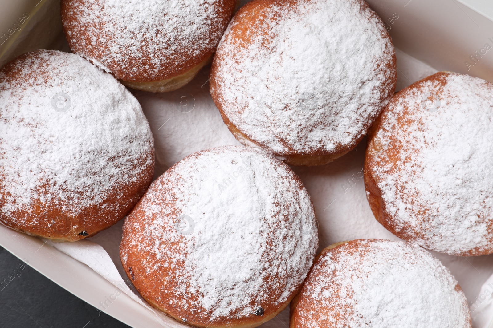 Photo of Delicious sweet buns in box, top view