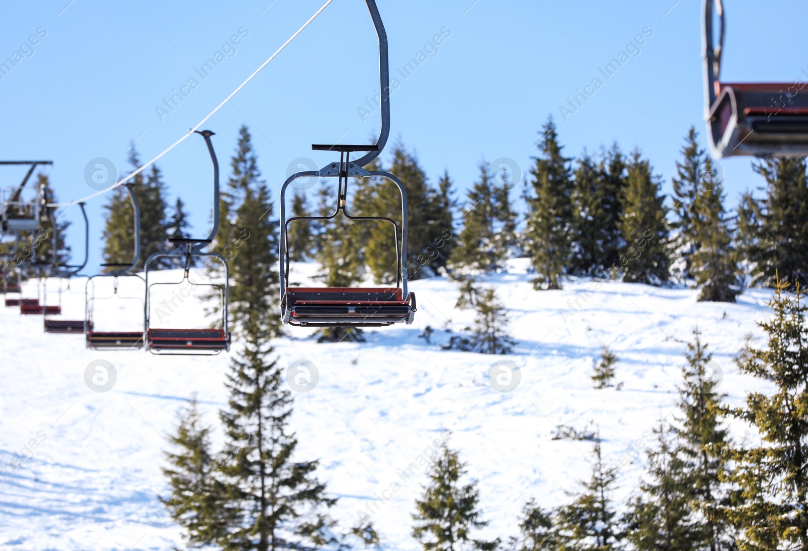 Photo of Empty chairlift at mountain ski resort. Winter vacation