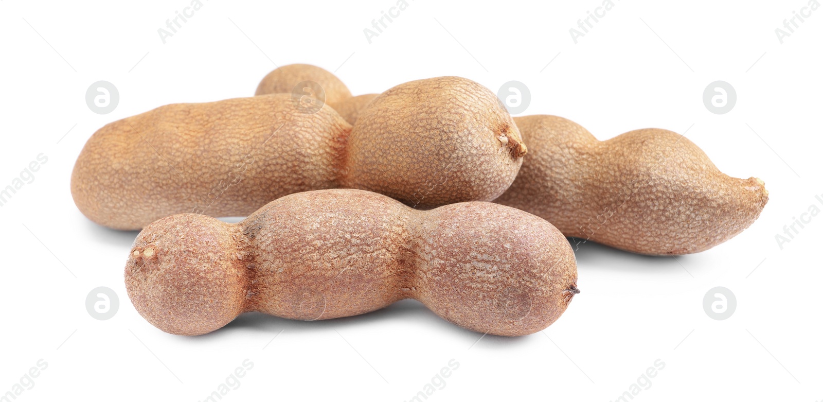 Photo of Delicious ripe tamarinds on white background. Exotic fruit