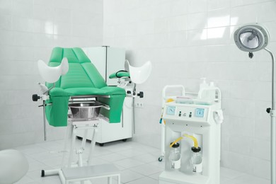 Modern gynecological office interior with examination chair and medical equipment