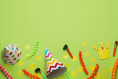 Flat lay composition with party items on light green background, space for text