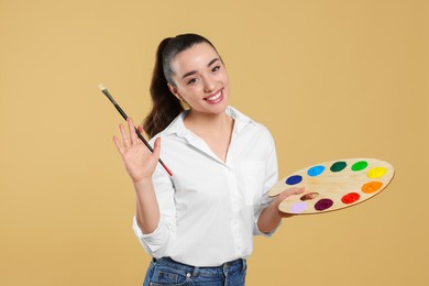 Woman with painting tools on beige background. Young artist