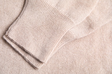 Warm cashmere sweater as background, top view