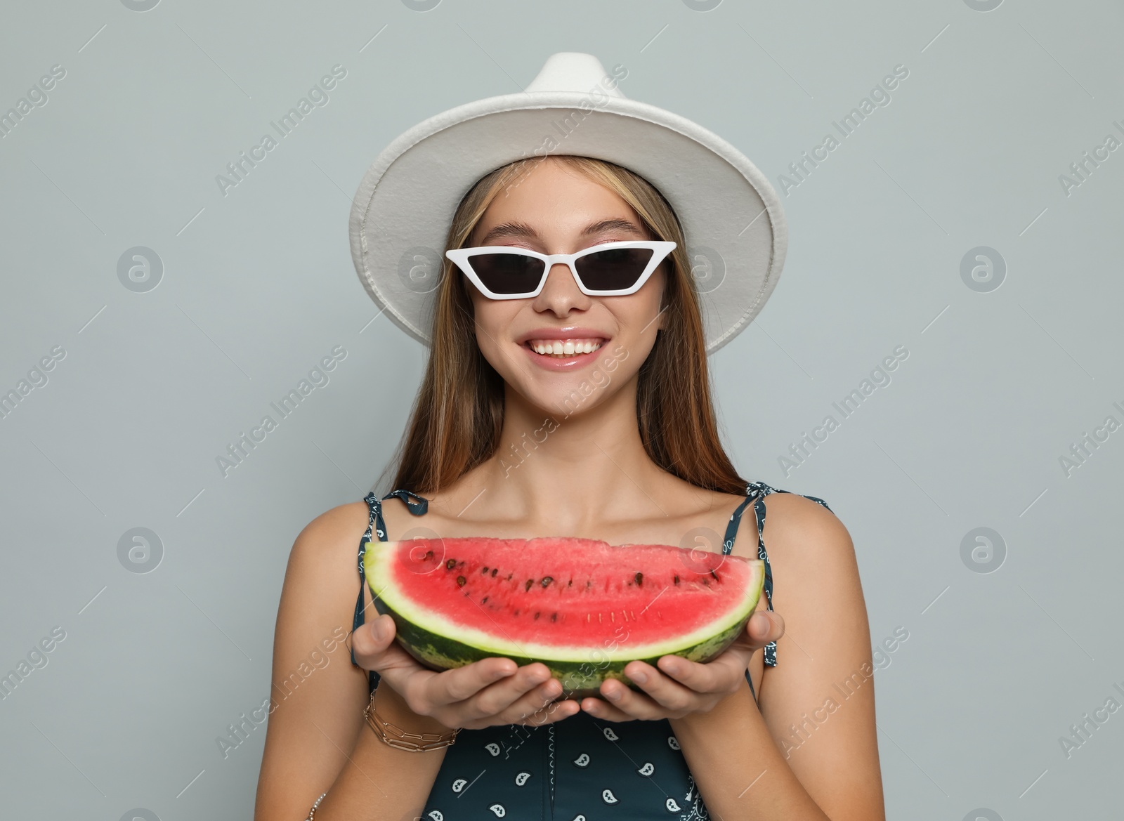 Photo of Beautiful girl with watermelon on grey background