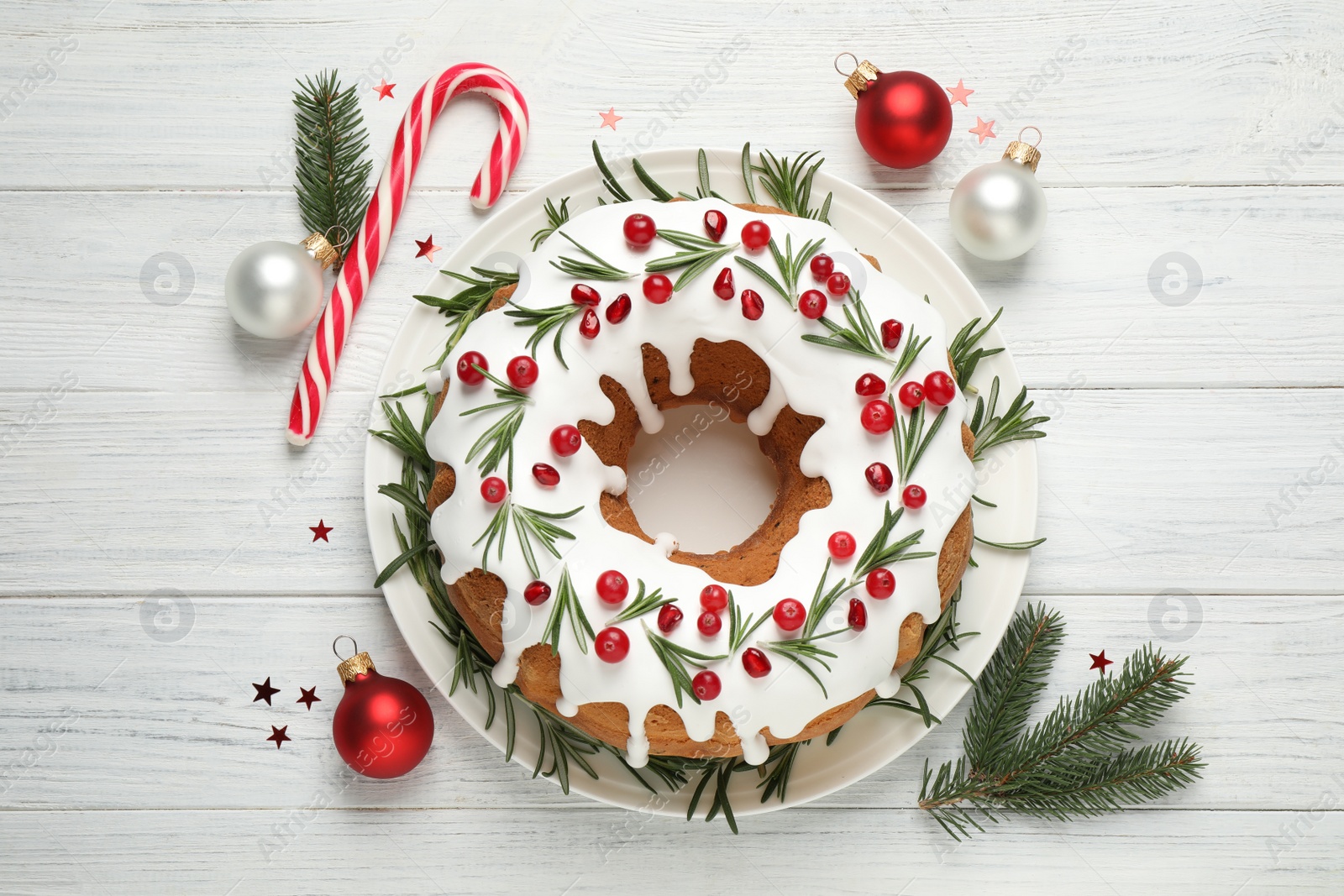 Photo of Flat lay composition with traditional Christmas cake decorations on white wooden table