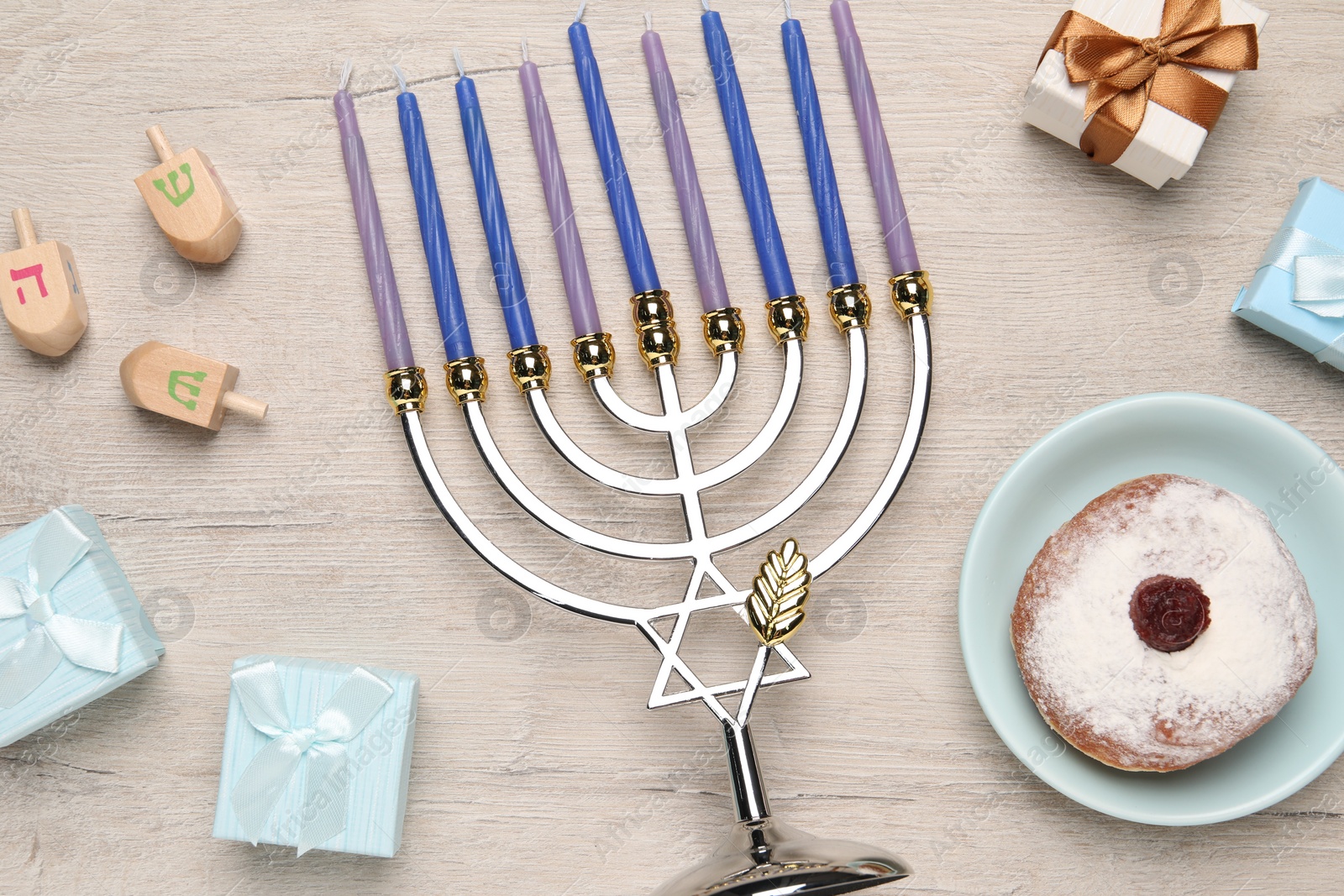 Photo of Flat lay composition with Hanukkah menorah and gift boxes on light wooden table