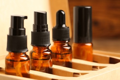 Photo of Bottles with oil in box, closeup. Natural cosmetics