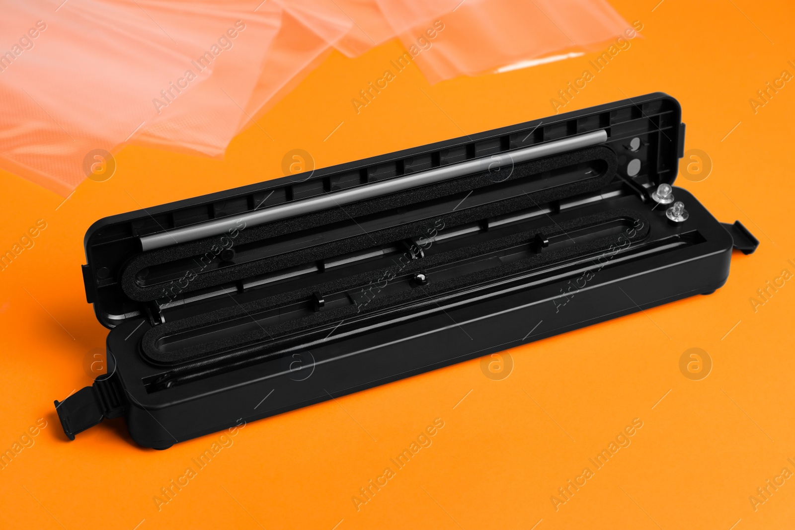 Photo of Sealer for vacuum packing on orange background