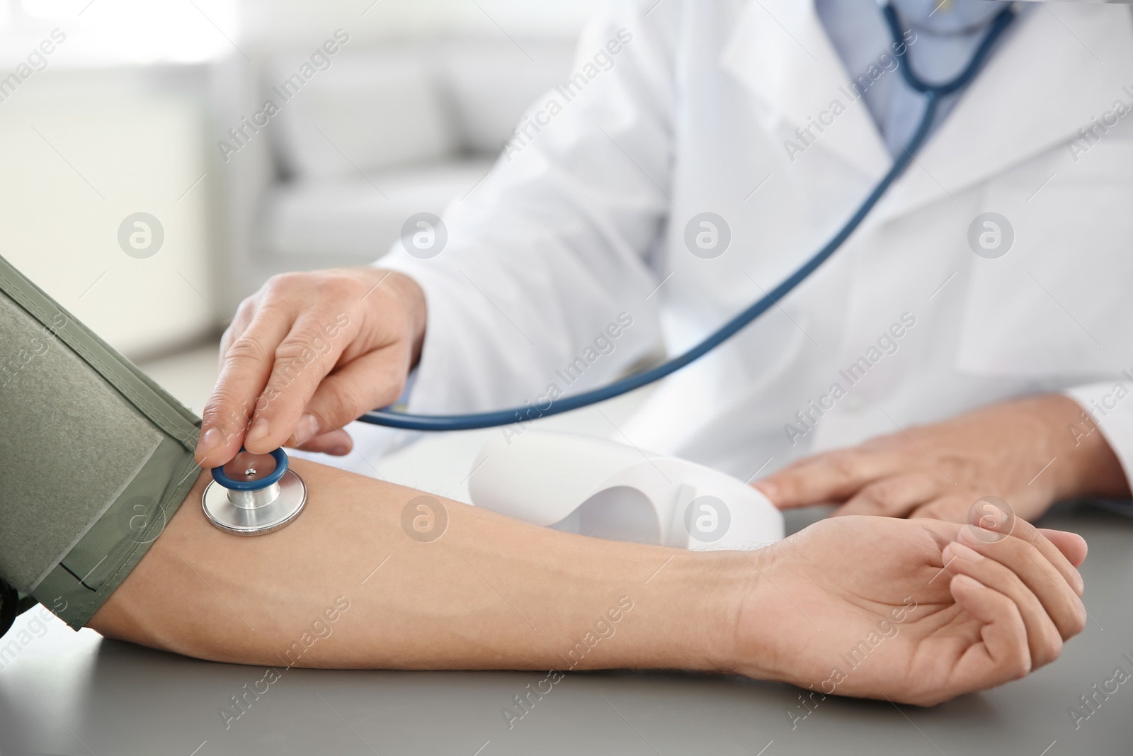 Photo of Doctor measuring patient's blood pressure in hospital