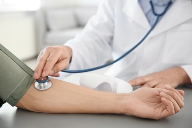 Photo of Doctor measuring patient's blood pressure in hospital