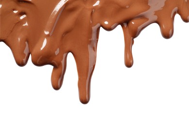 Photo of Tasty melted milk chocolate pouring down on white background