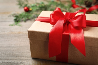 Photo of Christmas gift box on wooden background, closeup