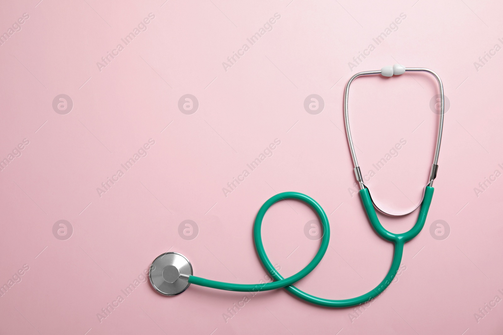 Photo of Stethoscope with space for text on color background, top view. Medical tool