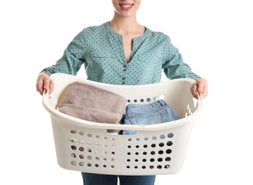 Young woman holding laundry basket with clothes on white background, closeup