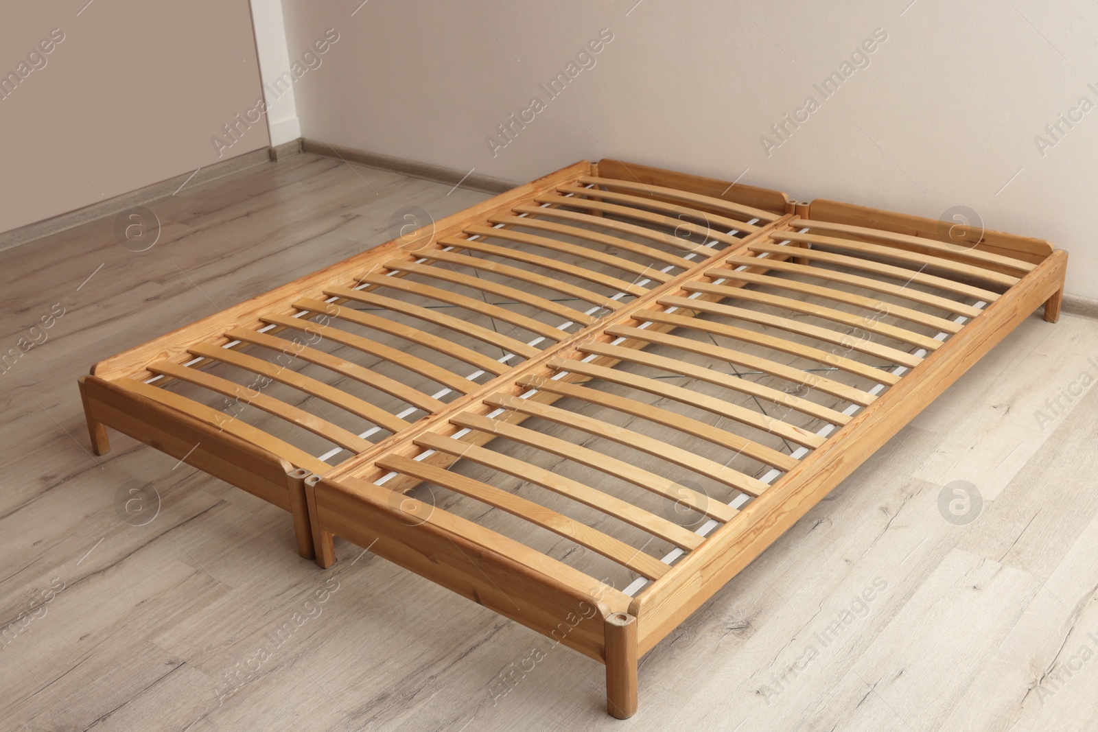 Photo of Wooden bed frame on floor in room