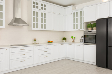 Photo of Modern kitchen interior with stylish white furniture