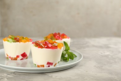 Photo of Delicious broken glass jelly dessert on white marble table, space for text