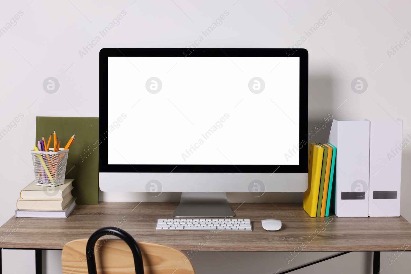 Photo of Cozy workspace with modern computer and stationery on wooden desk