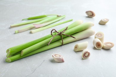 Whole and cut fresh lemongrass on light table