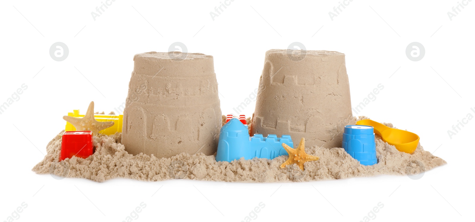 Photo of Plastic beach toys and figures on pile of sand against white background. Outdoor play