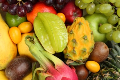 Photo of Assortment of fresh exotic fruits as background, top view