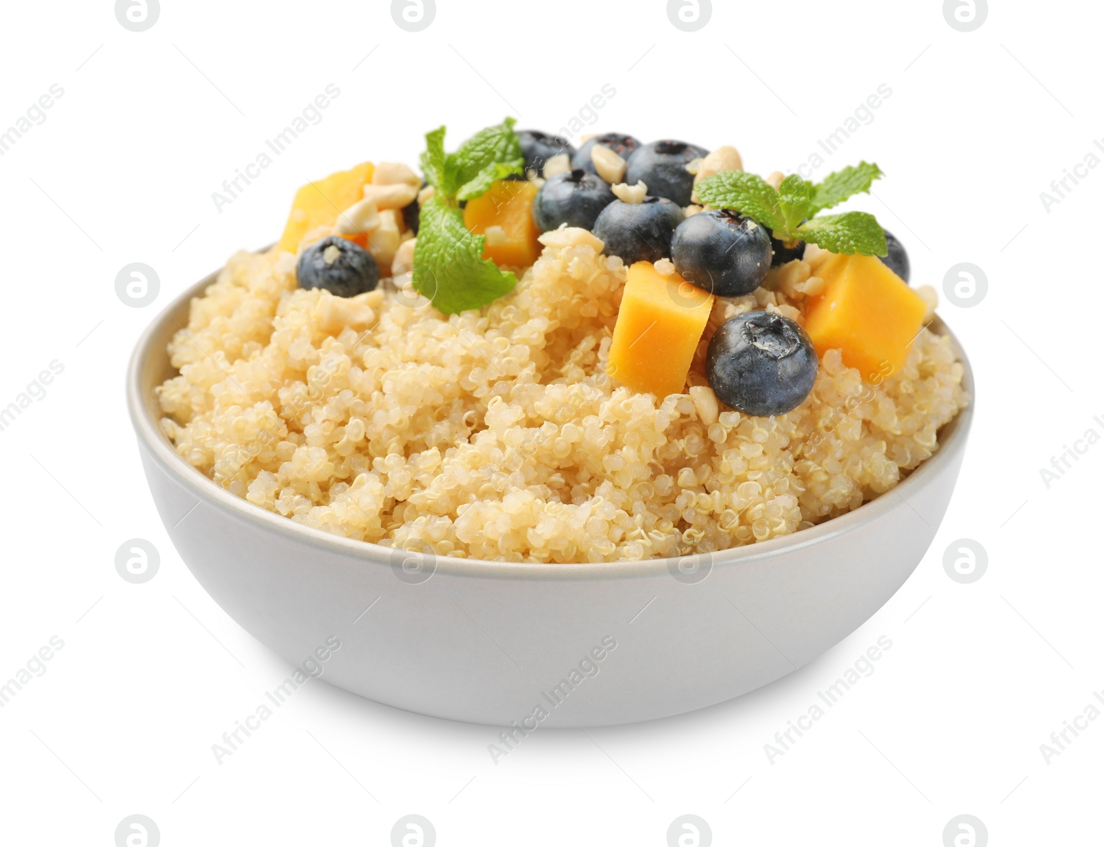 Photo of Tasty quinoa porridge with blueberries, pumpkin and mint in bowl isolated on white