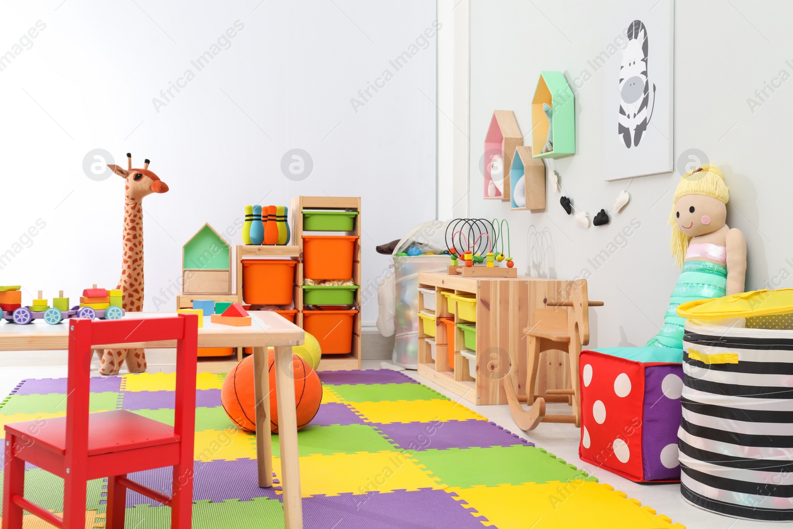 Photo of Cute child's room interior with toys and modern furniture