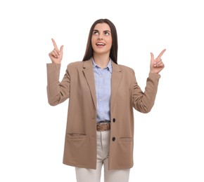 Beautiful businesswoman pointing at something on white background