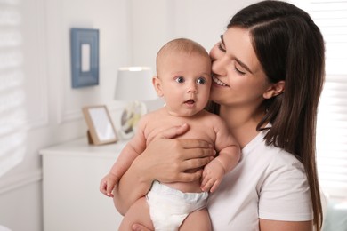 Happy young mother with her cute baby at home