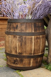 Photo of Traditional wooden barrel and beautiful decorative branches outdoors