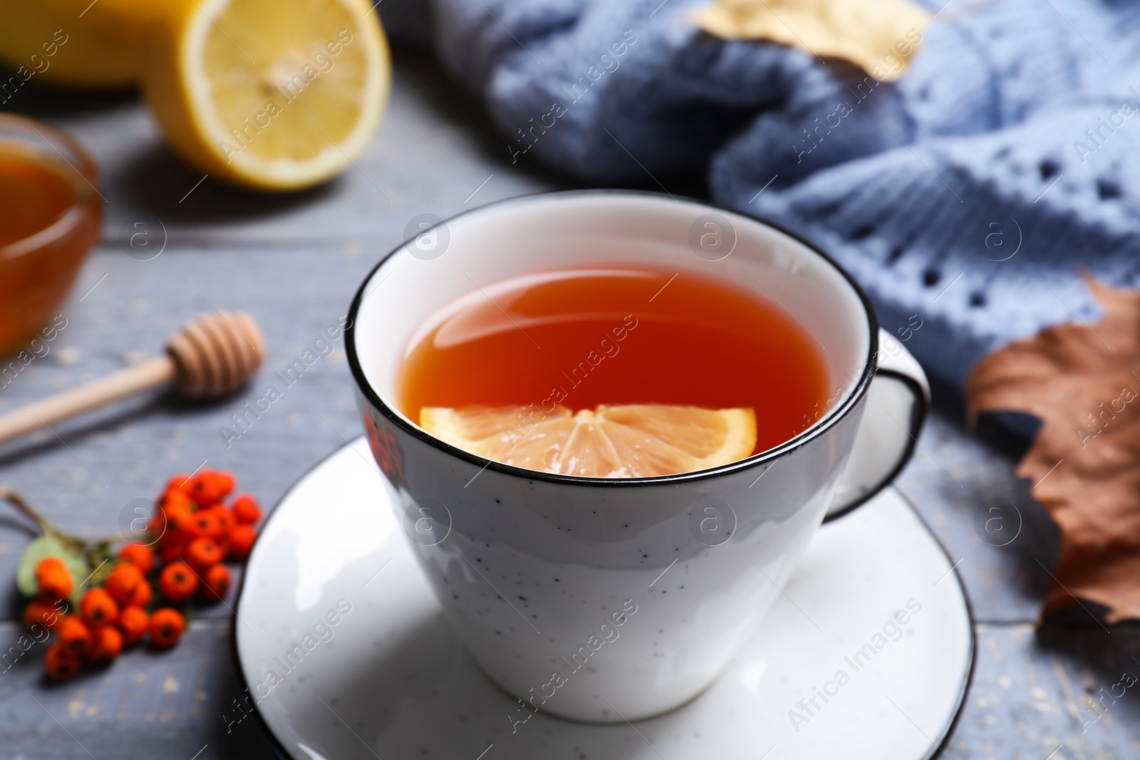 Photo of Cup of hot drink on grey wooden table, closeup. Cozy autumn atmosphere