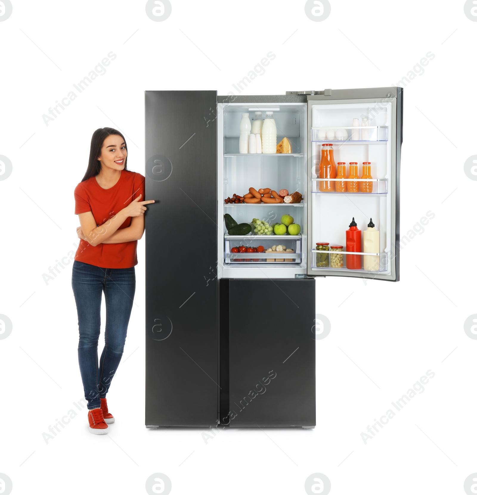 Photo of Young woman near open refrigerator on white background