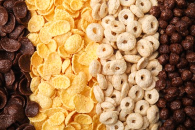 Photo of Different types of breakfast cereals as background, top view