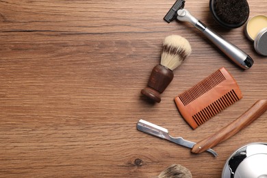 Photo of Moustache and beard styling tools on wooden background, flat lay. Space for text