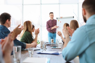 Photo of Male business trainer giving lecture in office