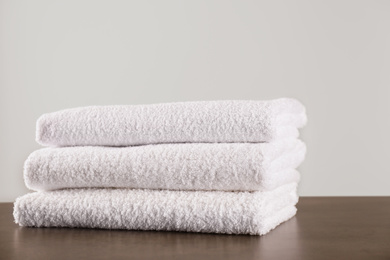 Stack of clean bath towels on dark grey table