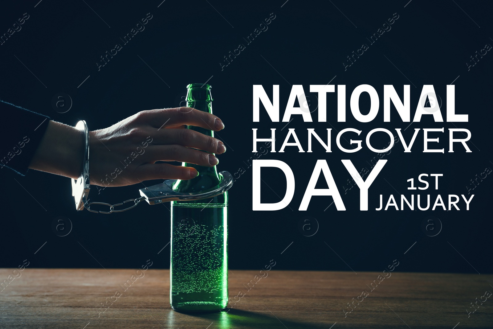 Image of National hangover day - January 1st. Woman handcuffed to bottle of beer against black background, closeup