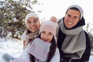 Happy family outdoors on winter day. Christmas vacation