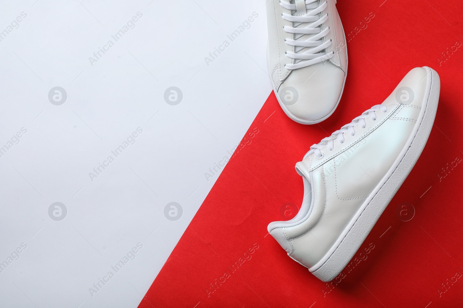 Photo of Pair of sneakers on color background, flat lay. Space for text