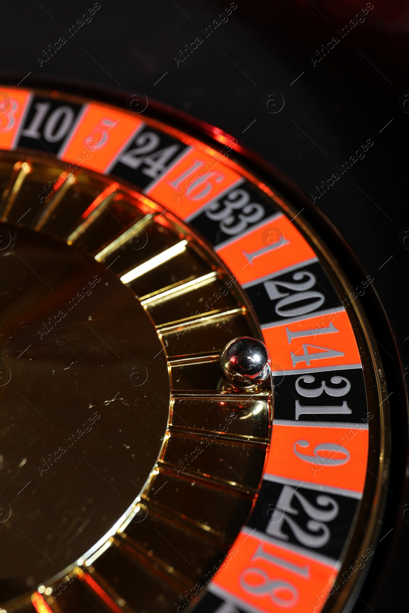 Photo of Roulette wheel with ball, closeup. Casino game