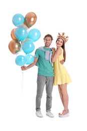 Photo of Young couple with air balloons on white background