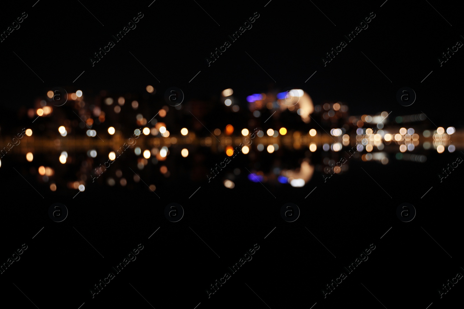 Photo of Blurred view of city street with lights at night. Bokeh effect