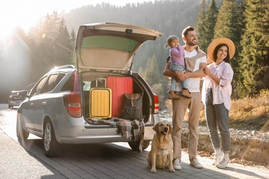 Parents, their daughter and dog near car outdoors. Family traveling with pet