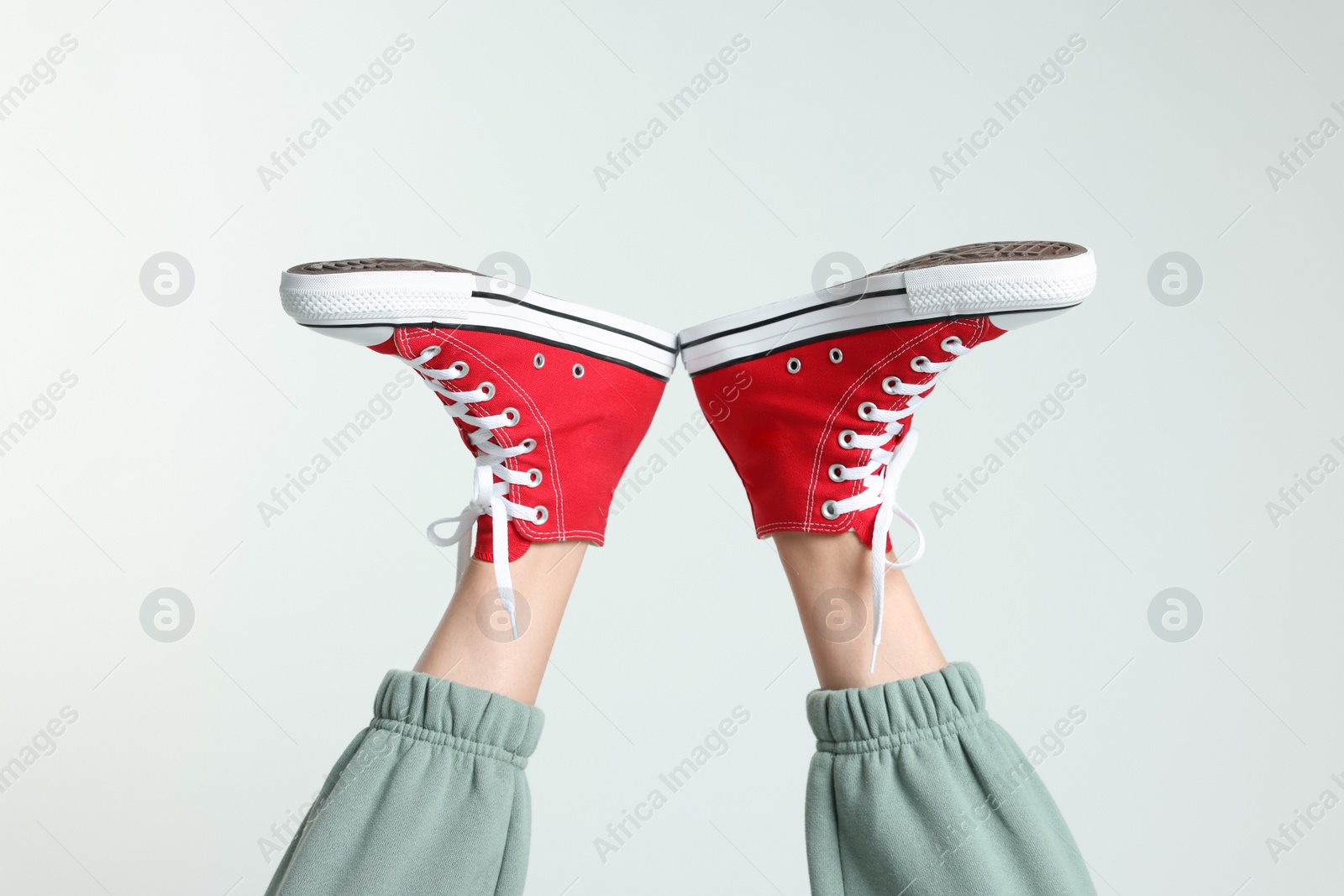 Photo of Woman in stylish gumshoes on white background, closeup