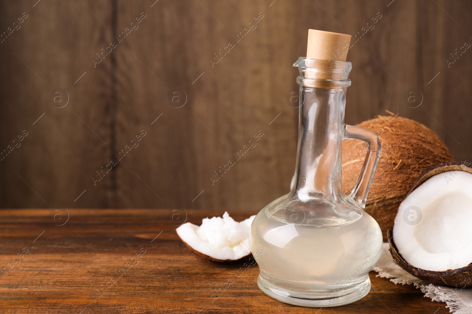 Photo of Coconut oil on wooden table. Space for text