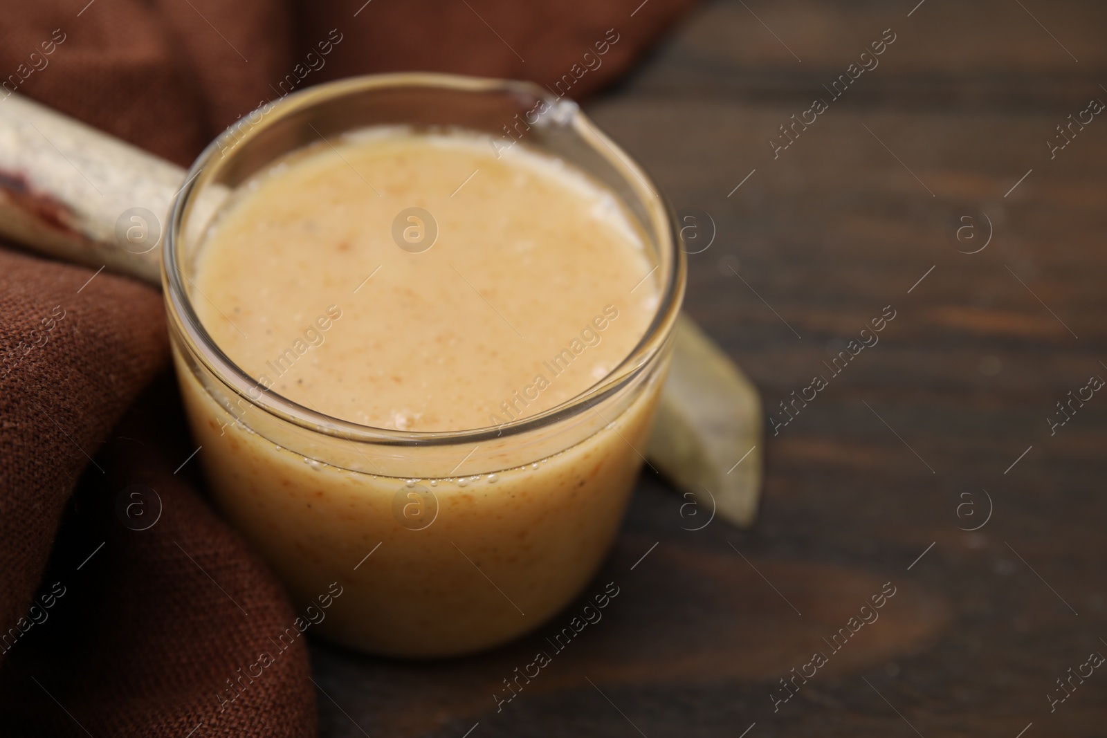 Photo of Delicious turkey gravy on wooden table, closeup. Space for text