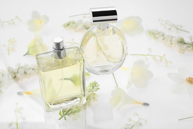 Two luxury perfumes on spring floral decor