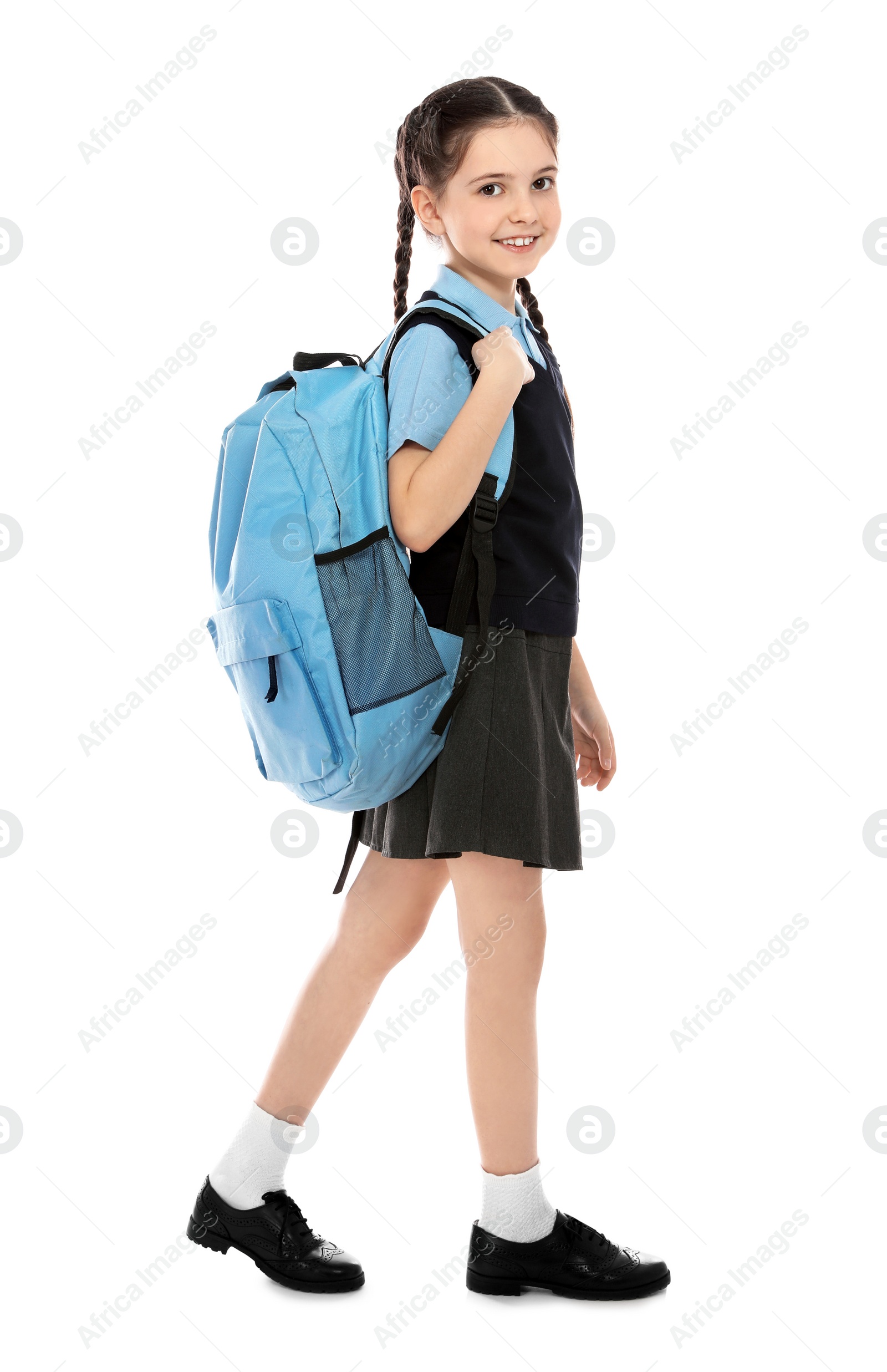 Photo of Full length portrait of cute girl in school uniform with backpack on white background