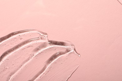 Cosmetic gel on pink background, top view. Space for text