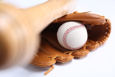 Photo of Baseball glove, bat and ball on white background, closeup